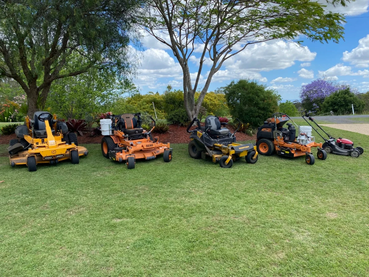 Callum's Mowing zero-turn and ride-on mowers lined up on an acreage block in the Lockyer Valley