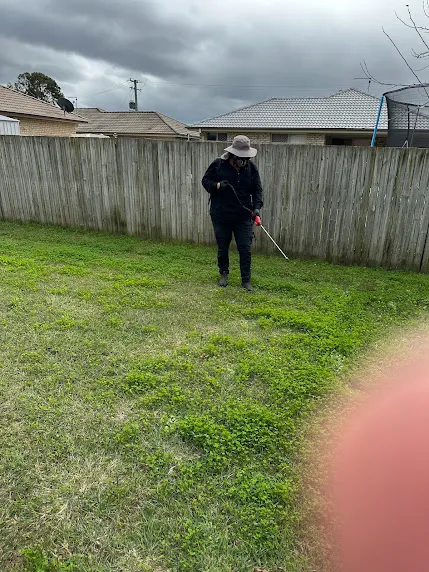 Spray unit applying selective weed treatment to a back lawn in the Lockyer Valley